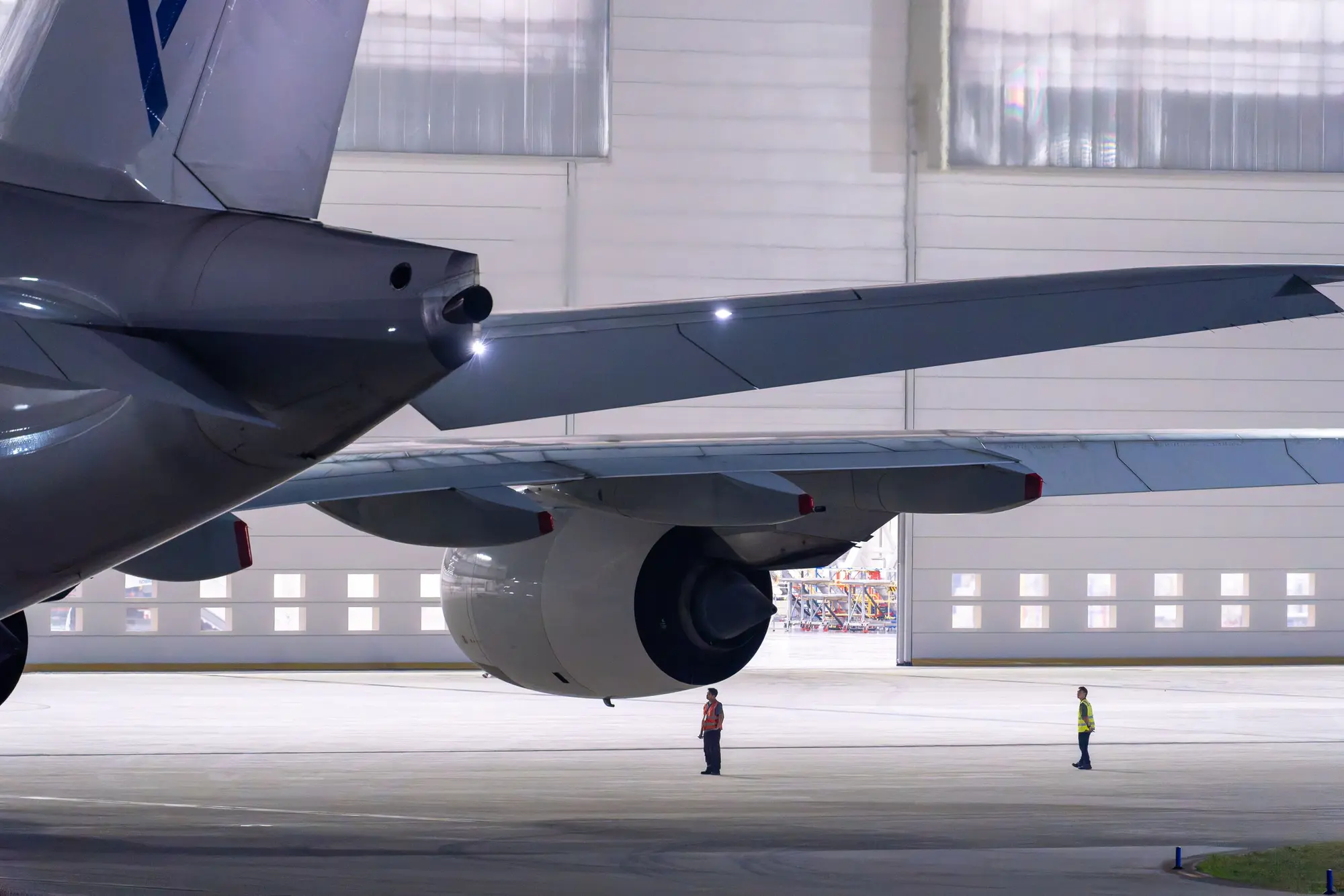 Maintenance crew inspecting an aircraft in the hangar